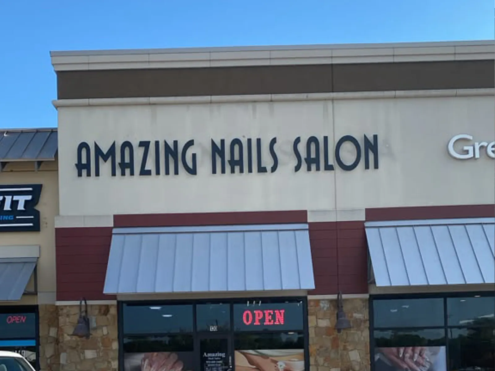 Amazing Nails Salon dark dimensional letters across a light retail fascia above metal awnings