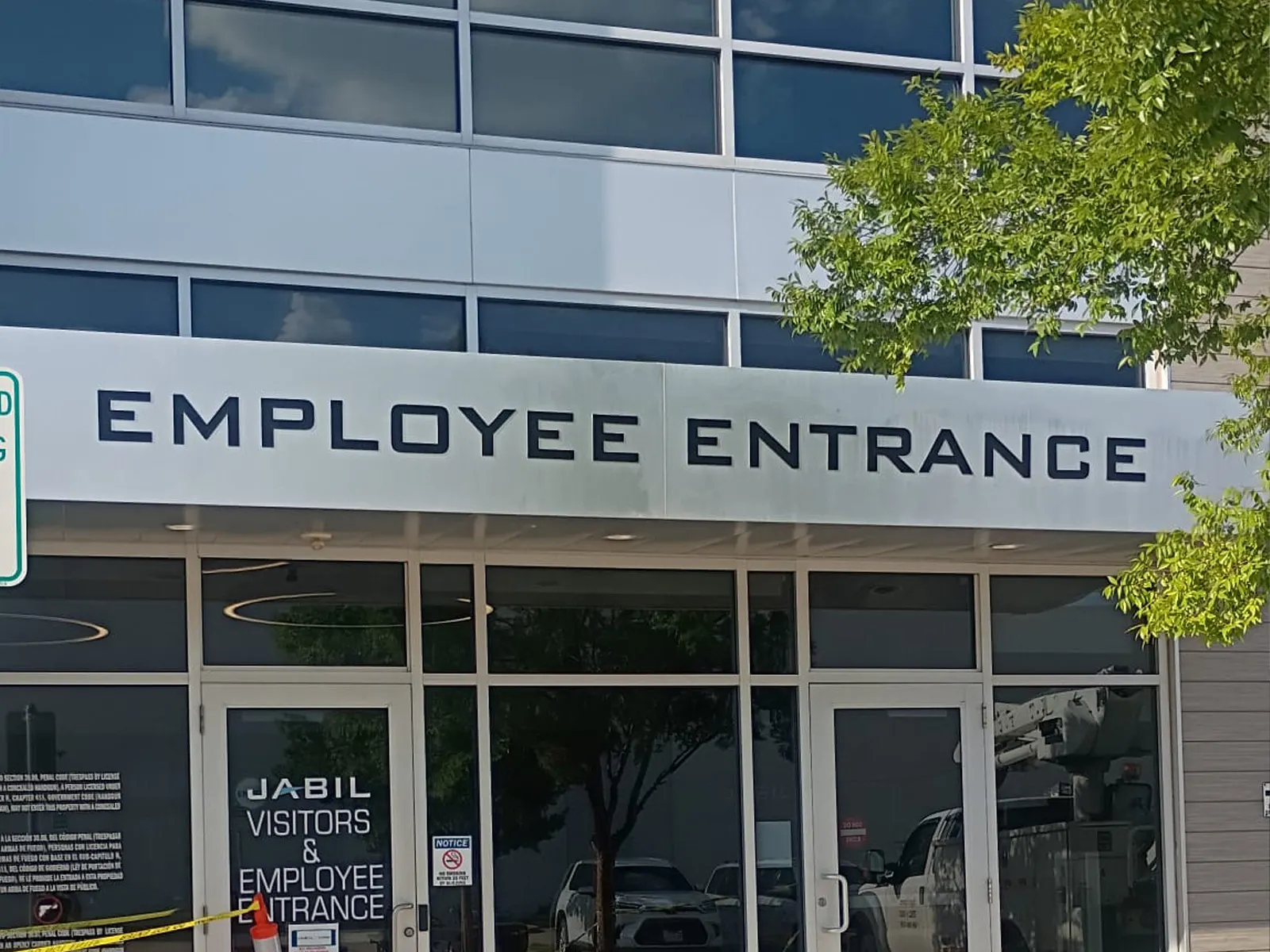Employee Entrance dimensional letters on a canopy fascia above the glass doors of a Jabil facility