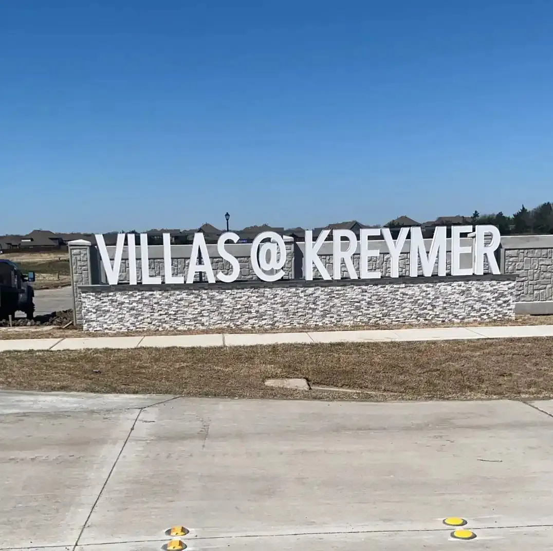 Villas at Kreymer dimensional letters on a long stone entrance monument